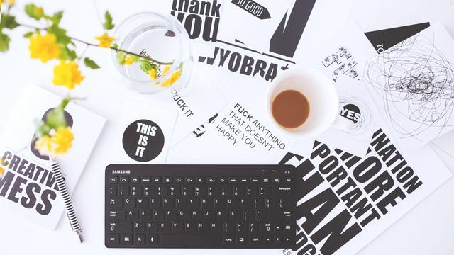 Big computer keyboard and paper designs in office